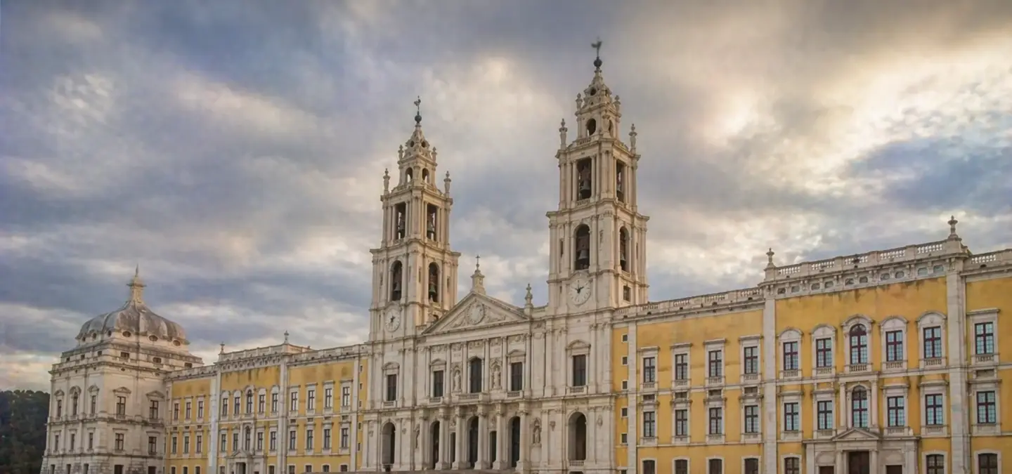 Mafra National Palace with twin Baroque bell towers and yellow facade under a cloudy sky