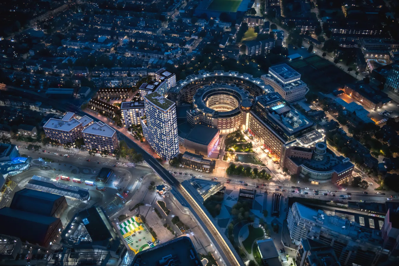 Best Property CGI Companies for Developers (2026) Aerial night view of an illuminated mixed-use city development for real estate CGI companies and property marketing