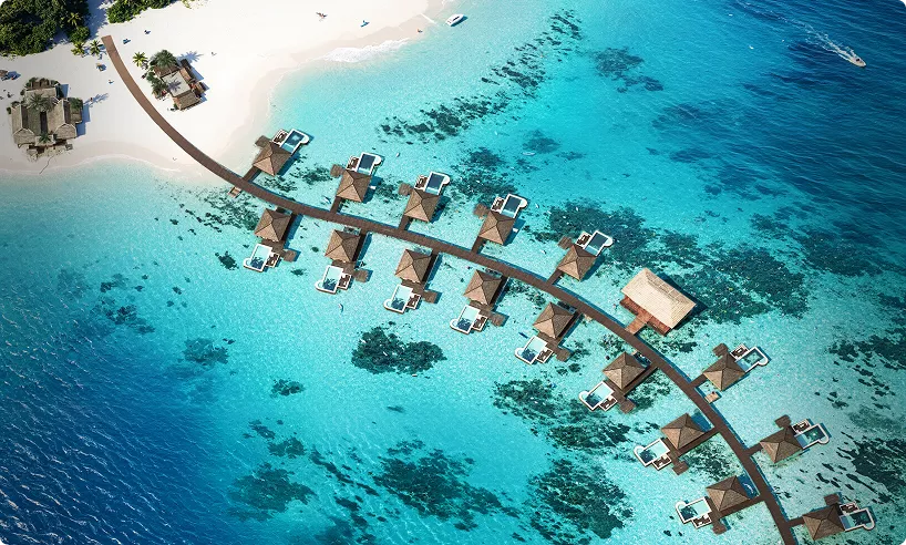 Tropical resort hero image with overwater villas and clear turquoise ocean aerial view