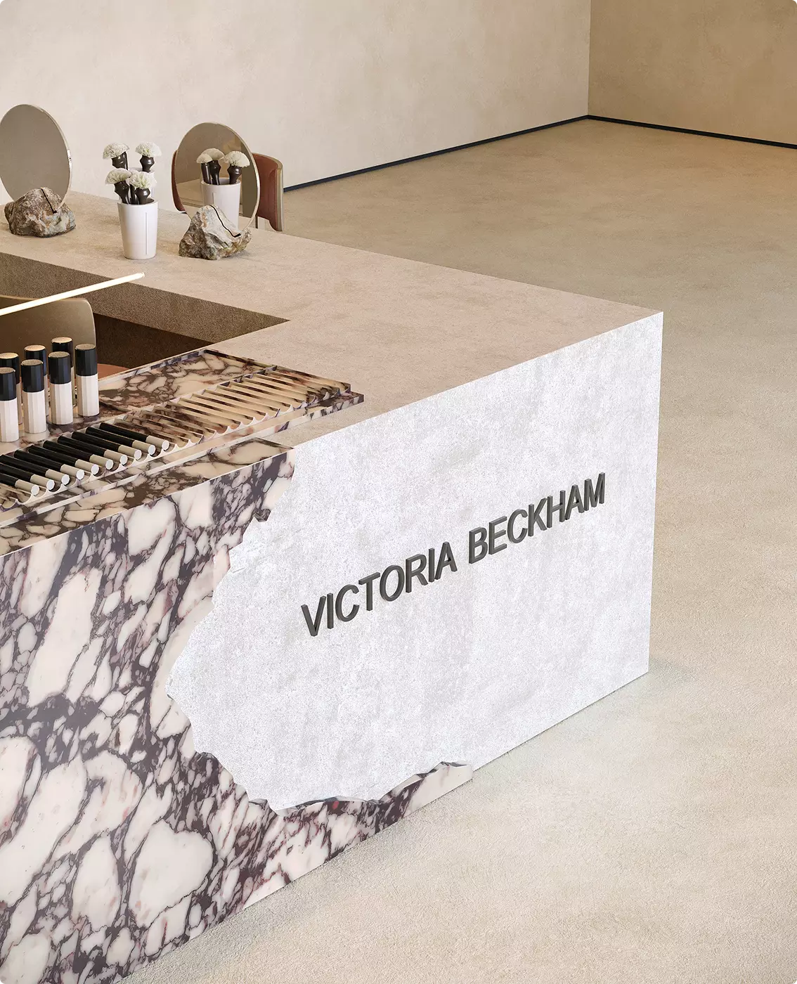Close-up of branded marble counter design in a luxury beauty retail environment with premium cosmetic product presentation.