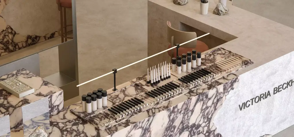 High-end beauty retail product display featuring organized makeup testers, luxury finishes, and minimalist merchandising details.