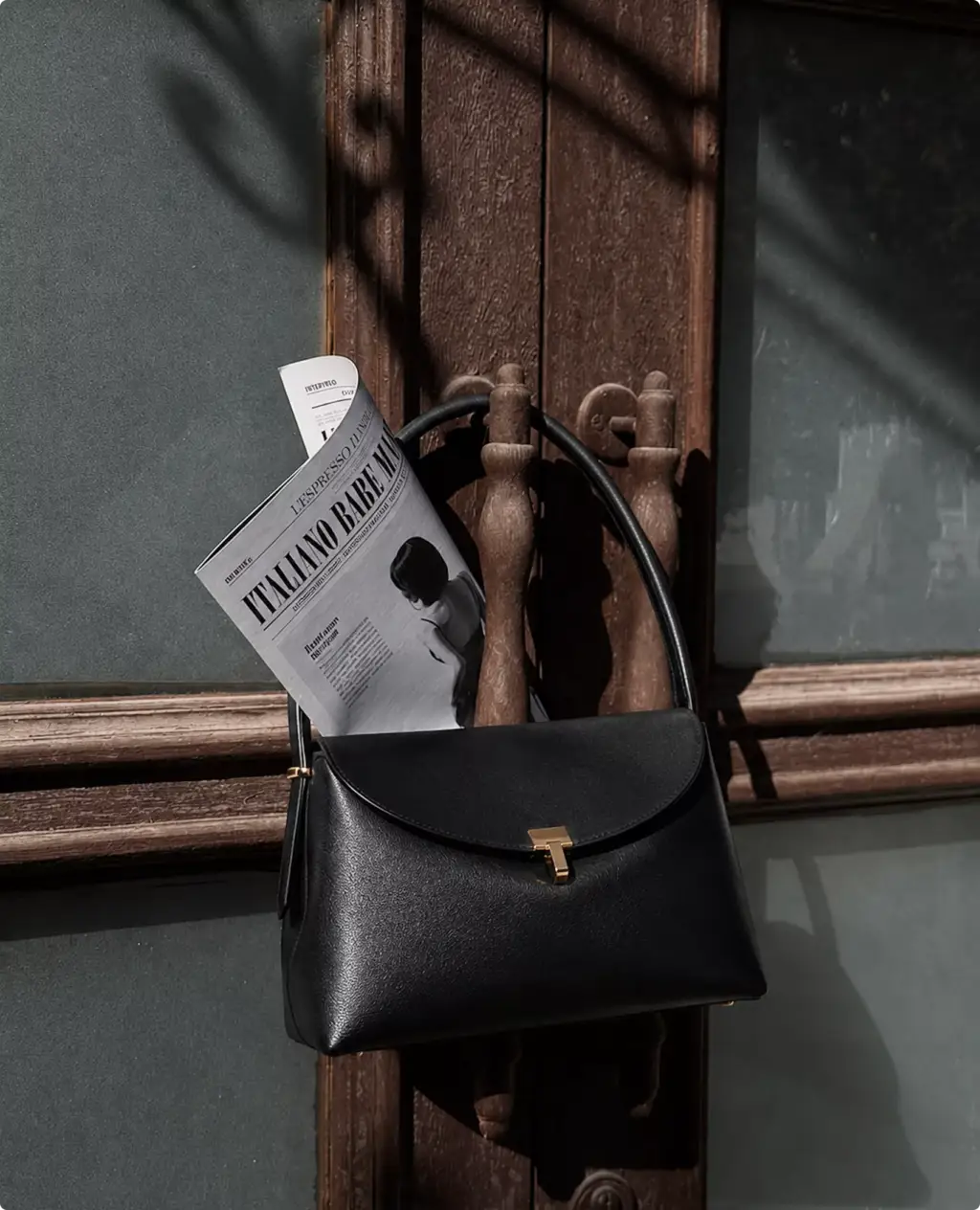 Photorealistic Toteme handbag CGI render hanging on carved wooden door