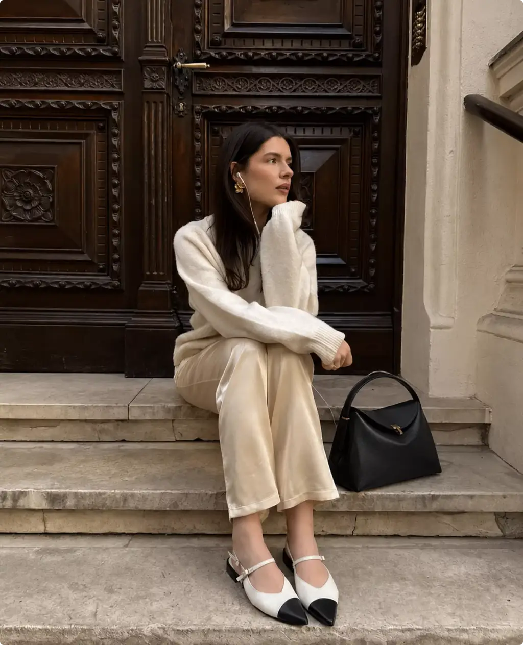 Photorealistic Toteme handbag CGI render beside seated model on marble steps