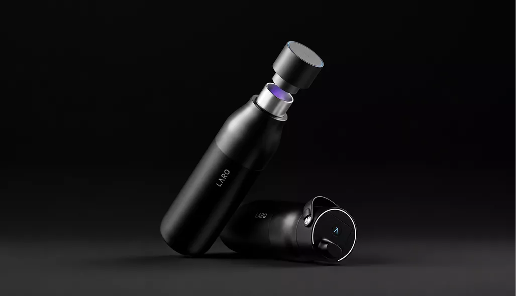 Smart water bottle CGI with glowing UV cap and matte black bottle on dark surface