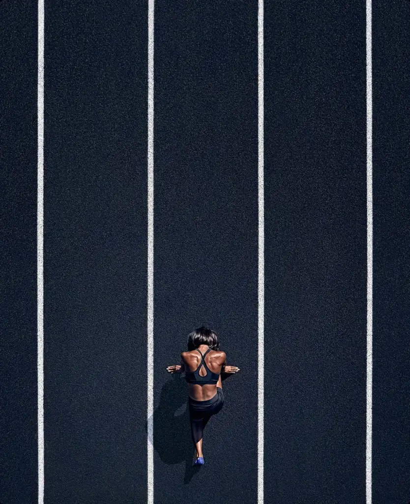 Athlete in a spotlight on a dark court, sports brand world.
