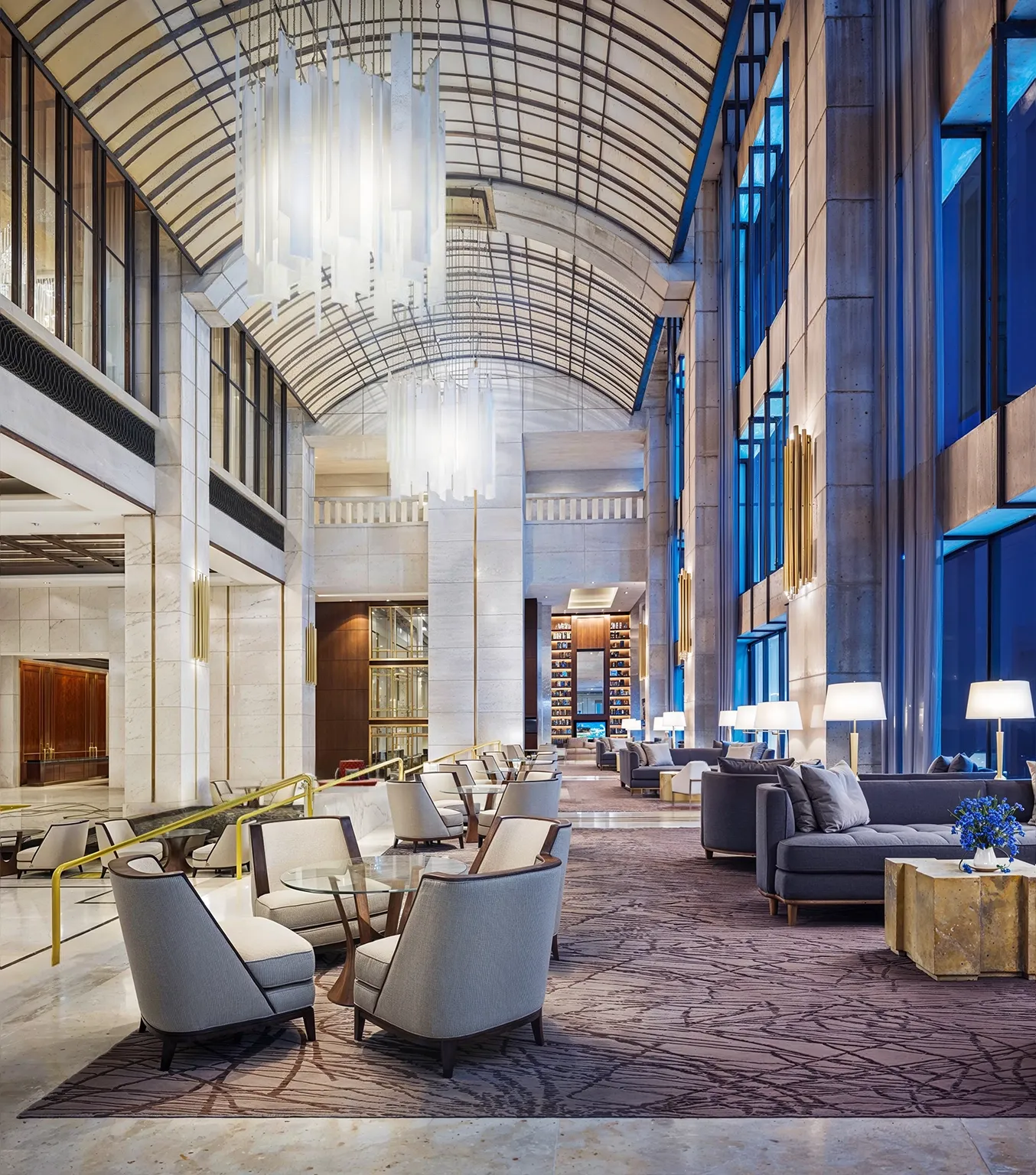 Best 3D Interior Rendering Companies in 2026 Luxury hotel lounge with vaulted glass ceiling, lounge seating, and hospitality lighting