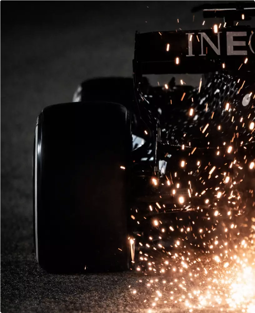 Custom luxury car CGI race car rear tire with sparks on track in low light
