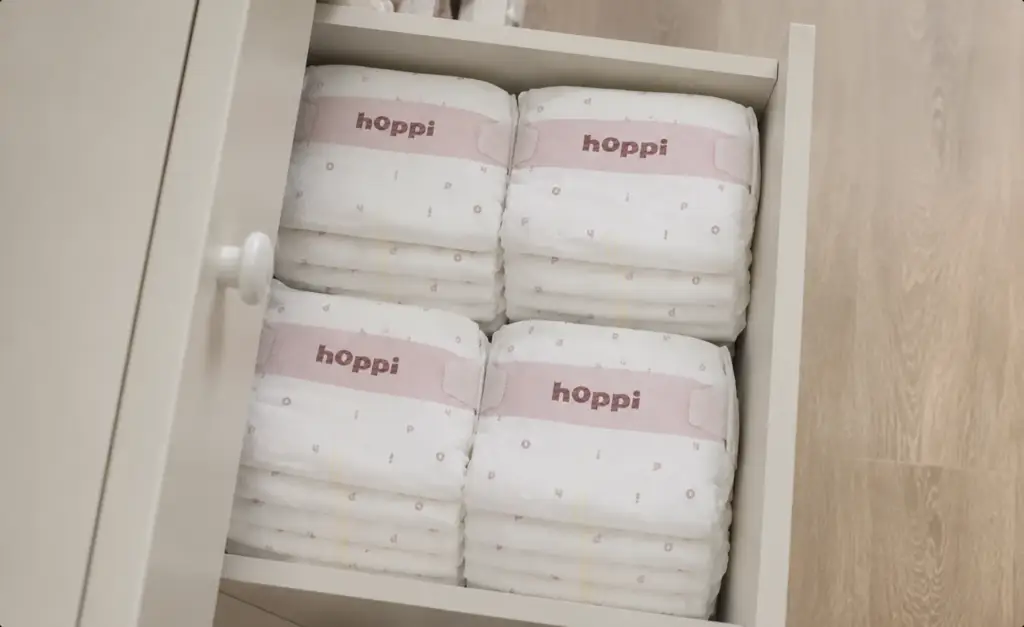 hoppi diapers neatly organised in a nursery drawer, baby diaper lifestyle render.