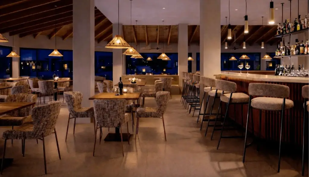 Warm hotel lounge 3D visualization with bar seating, woven chairs, pendant lights, and wood ceiling