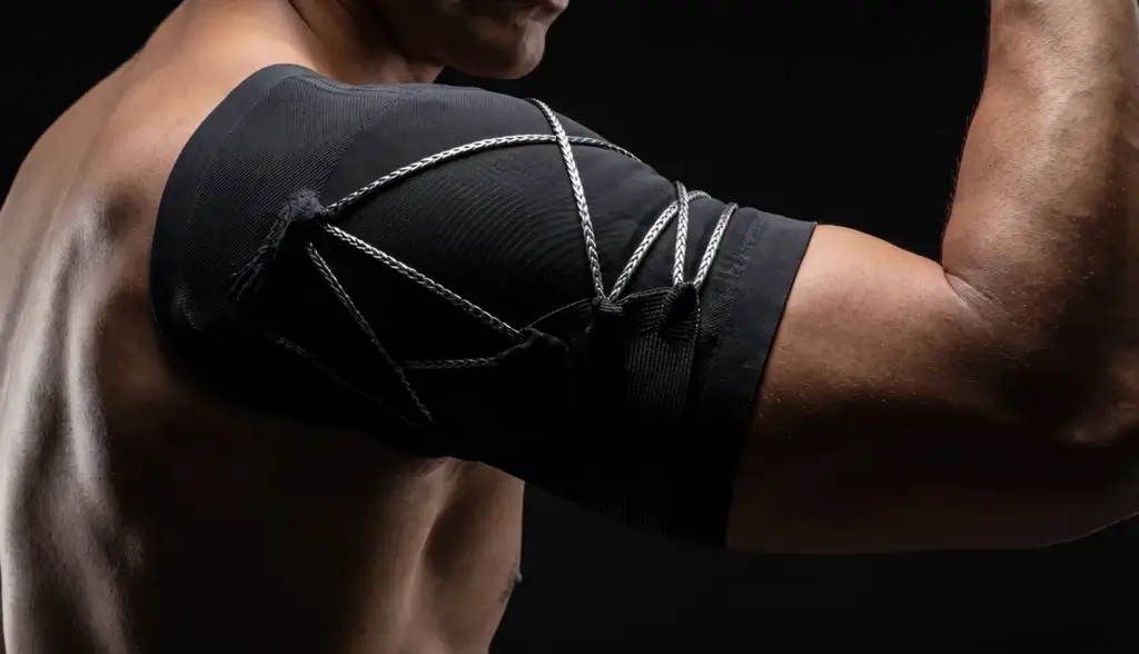 Close-up of a knee compression support on an athlete, technical material detail.