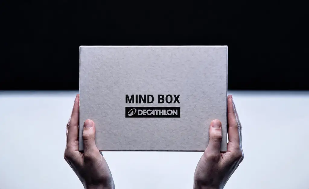 Hands holding a Decathlon Mind Box.