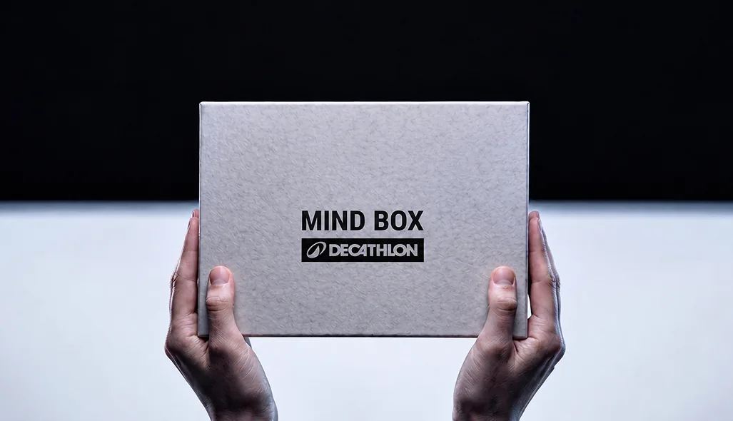 Hands holding a closed Decathlon Mind Box.