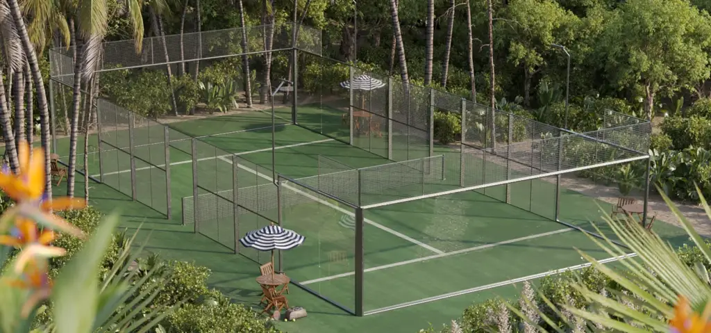 Aerial key visual CGI of the padel court showing the estate footprint, surrounding landscape, and pool integration.