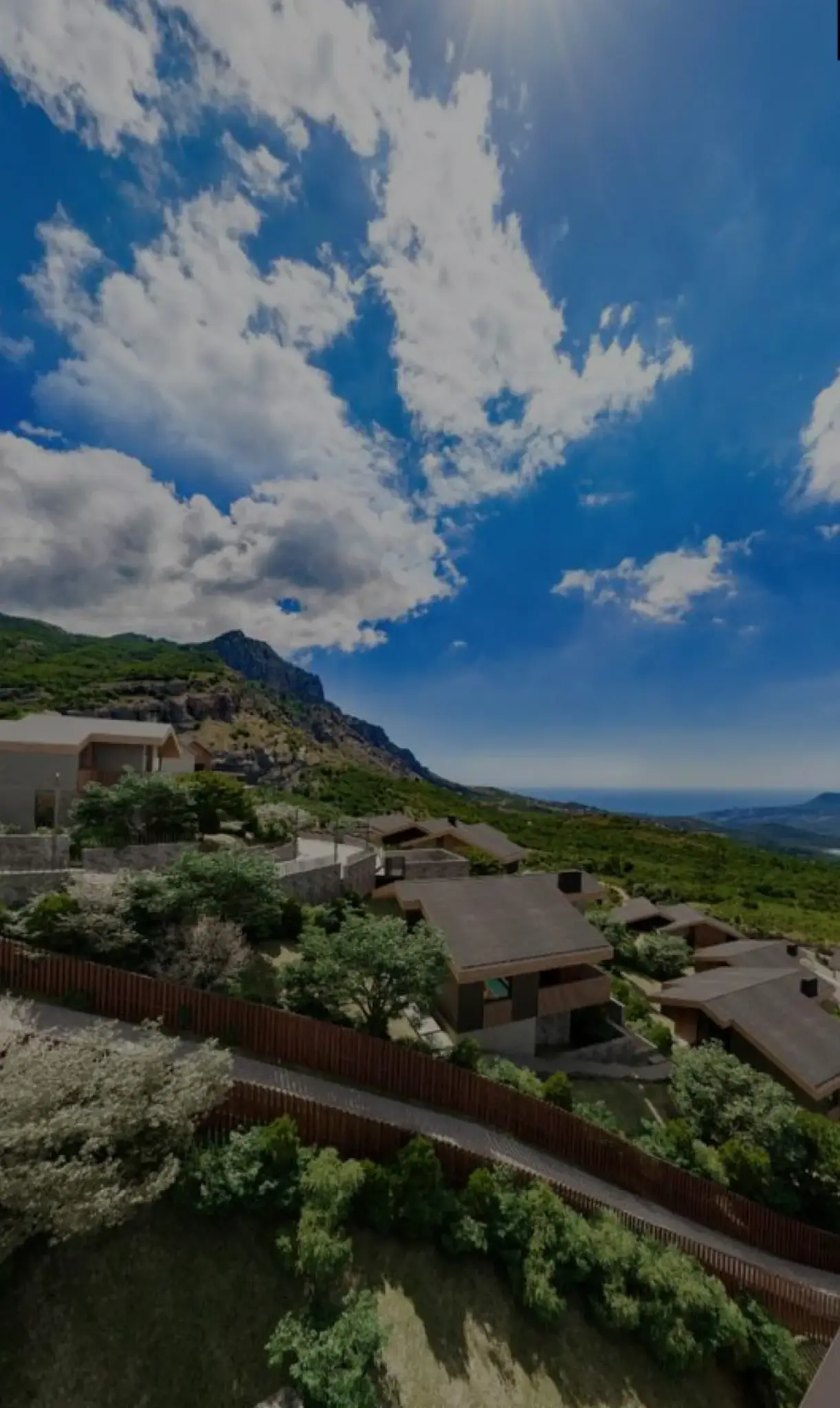Wide sky panorama with dramatic clouds over mountainous terrain