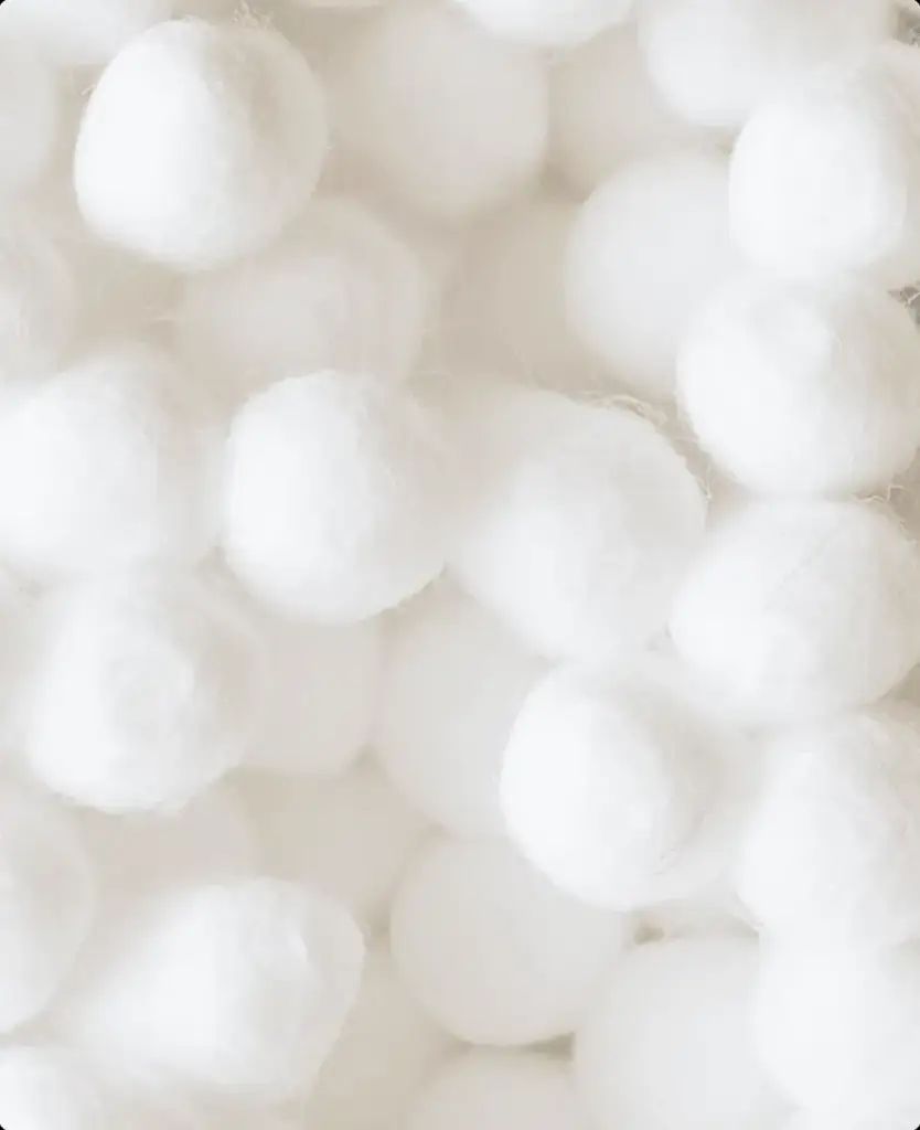 Soft white cotton balls representing gentle diaper materials, baby diaper product visualization.