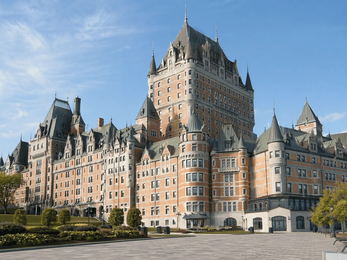 Victorian Architecture: A Complete Guide to Its History and Styles Historic Quebec hotel with steep copper roofs, turrets, and castle-like Victorian form