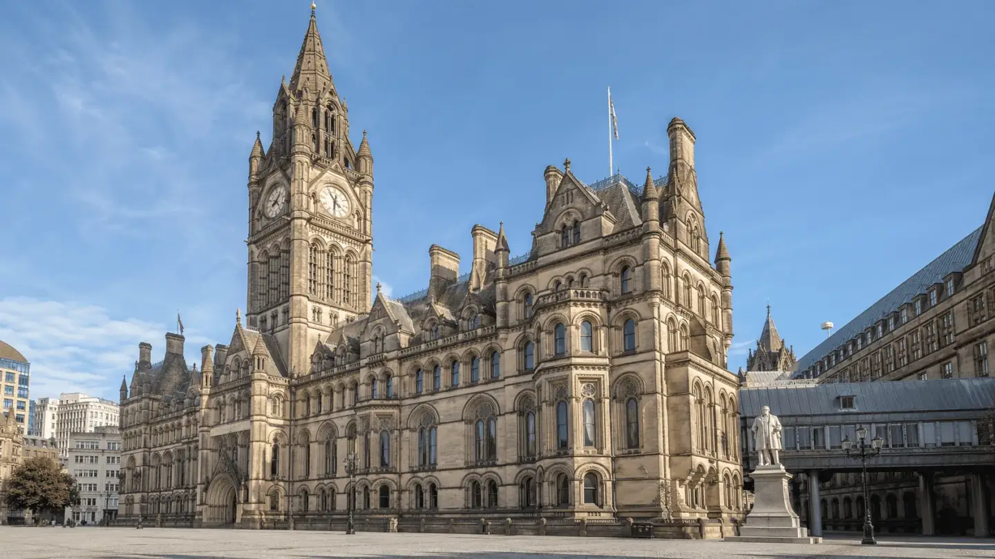 Victorian Architecture: A Complete Guide to Its History and Styles Stone city hall with clock tower, arched windows, and ornate Victorian civic facade