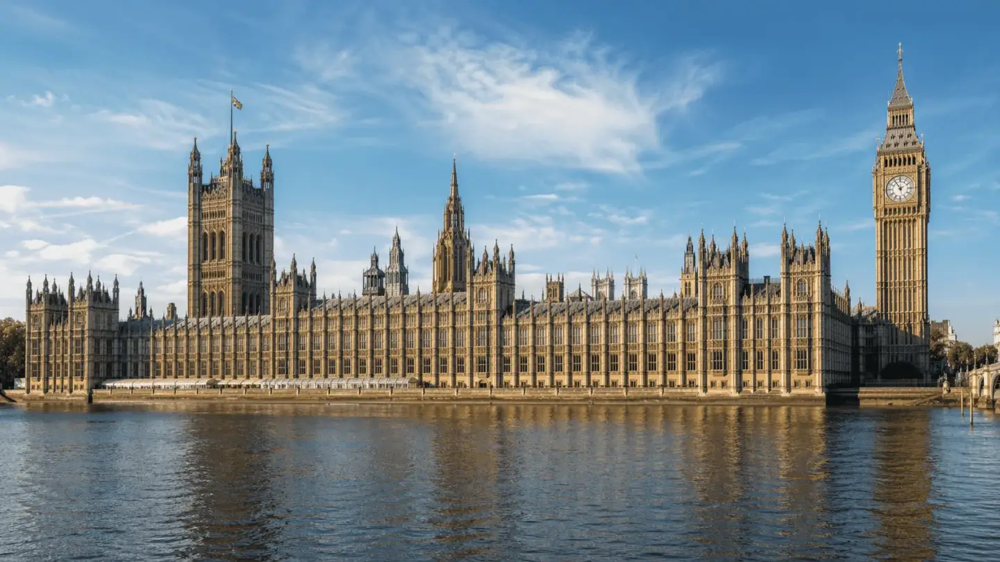 Palace of Westminster beside the Thames with Gothic towers and clock tower in London