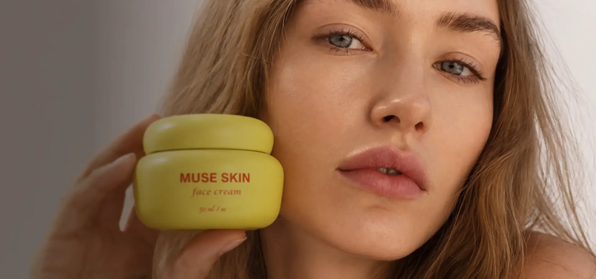 Beauty model with a yellow face-cream jar near her cheek, AI product visualization for a skincare brand.